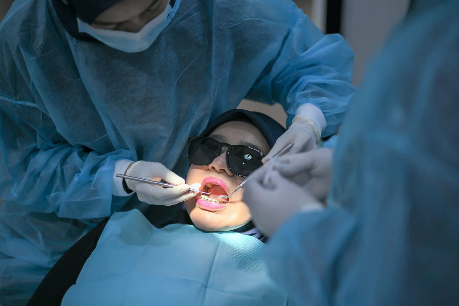 A dentist checking a child’s teeth